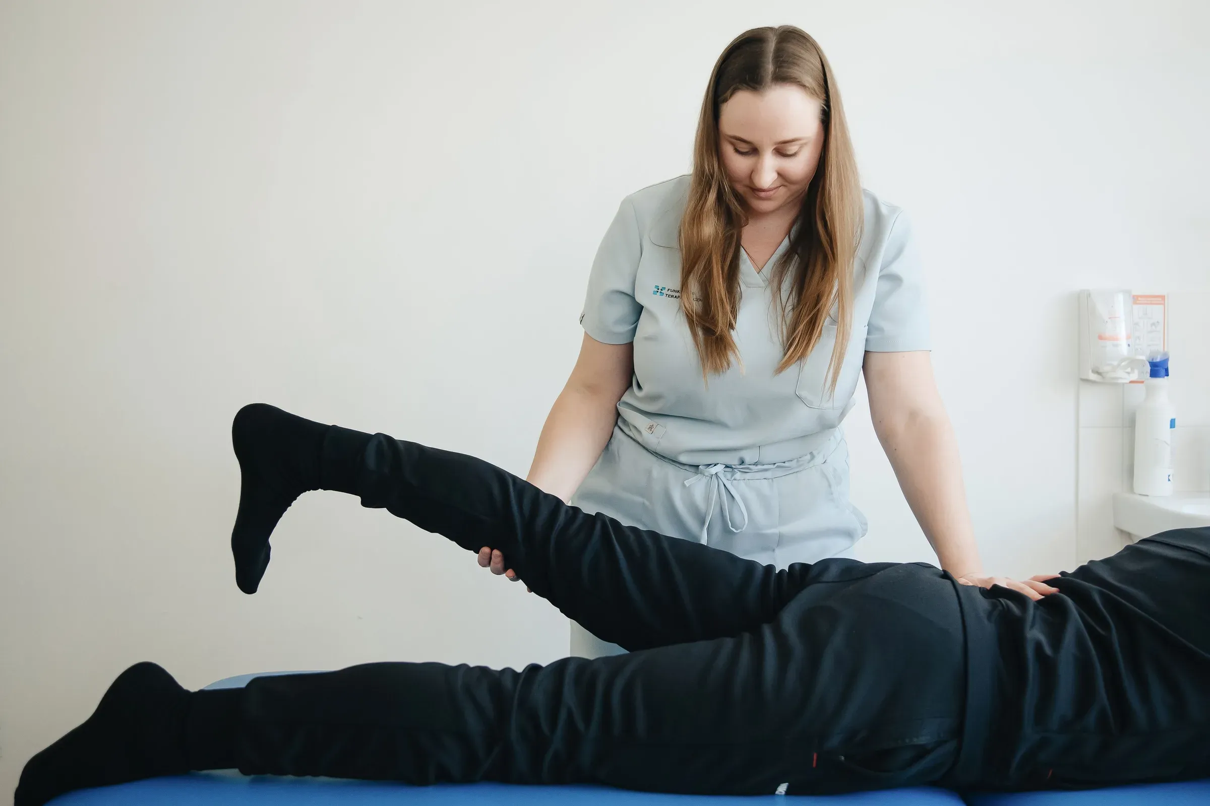 Caregiver assisting a person during rehabilitation